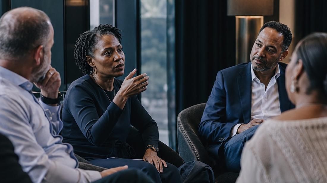 Executives in an intimate peer forum discussion